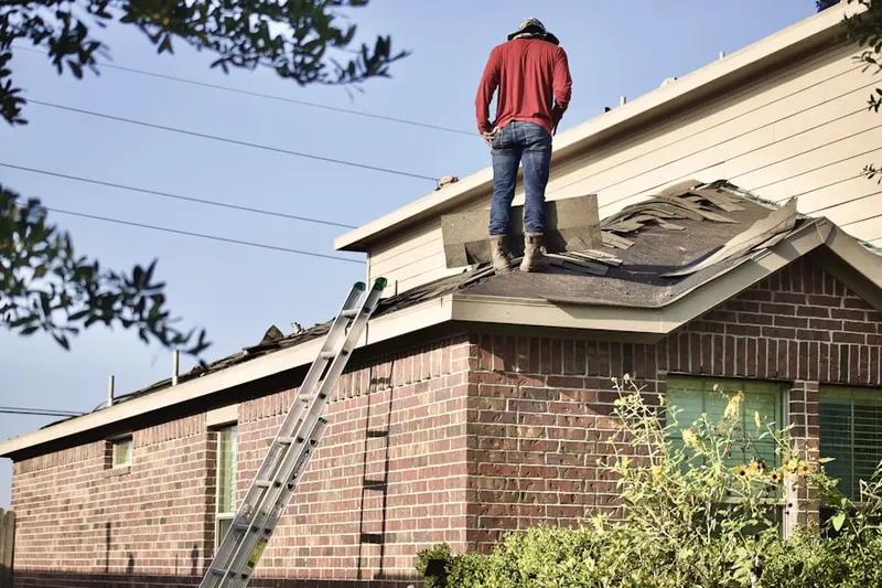 Professional roofer working on a residential roof in Xenia